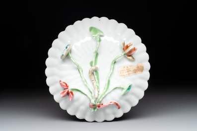 A Chinese famille rose 'rooster' teapot with applied floral design, two cups and a saucer, Yongzheng/Qianlong