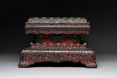 A Chinese rectangular carved red and black lacquer stand, 20th C.