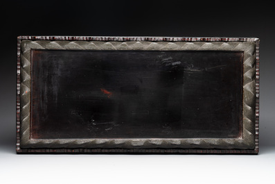 A Chinese rectangular carved red and black lacquer stand, 20th C.