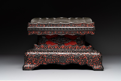 A Chinese rectangular carved red and black lacquer stand, 20th C.