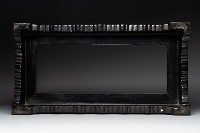 A Chinese rectangular carved red and black lacquer stand, 20th C.