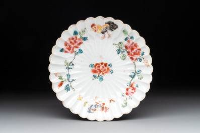 A Chinese famille rose 'rooster' teapot with applied floral design, two cups and a saucer, Yongzheng/Qianlong