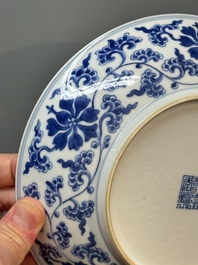 A pair of imperial Chinese blue and white 'lotus scroll' plates, Qianlong mark and of the period