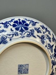 A pair of imperial Chinese blue and white 'lotus scroll' plates, Qianlong mark and of the period