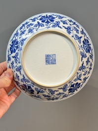A pair of imperial Chinese blue and white 'lotus scroll' plates, Qianlong mark and of the period