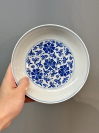 A pair of imperial Chinese blue and white 'lotus scroll' plates, Qianlong mark and of the period