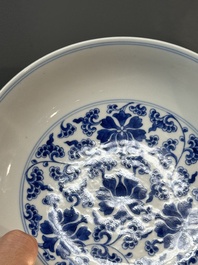 A pair of imperial Chinese blue and white 'lotus scroll' plates, Qianlong mark and of the period