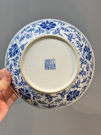 A pair of imperial Chinese blue and white 'lotus scroll' plates, Qianlong mark and of the period