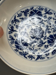 A pair of imperial Chinese blue and white 'lotus scroll' plates, Qianlong mark and of the period