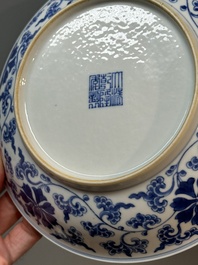 A pair of imperial Chinese blue and white 'lotus scroll' plates, Qianlong mark and of the period