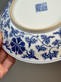 A pair of imperial Chinese blue and white 'lotus scroll' plates, Qianlong mark and of the period