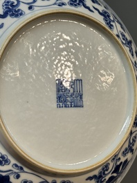 A pair of imperial Chinese blue and white 'lotus scroll' plates, Qianlong mark and of the period