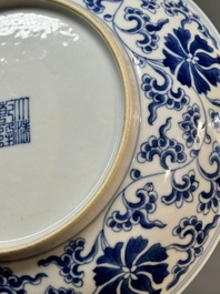 A pair of imperial Chinese blue and white 'lotus scroll' plates, Qianlong mark and of the period
