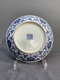 A pair of imperial Chinese blue and white 'lotus scroll' plates, Qianlong mark and of the period