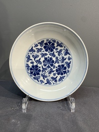 A pair of imperial Chinese blue and white 'lotus scroll' plates, Qianlong mark and of the period