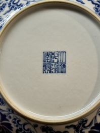 A pair of imperial Chinese blue and white 'lotus scroll' plates, Qianlong mark and of the period