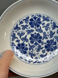 A pair of imperial Chinese blue and white 'lotus scroll' plates, Qianlong mark and of the period