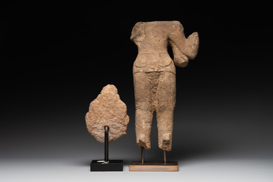 A sandstone torso and a Buddha head, Cambodia, late Khmer period, 13/14th C.