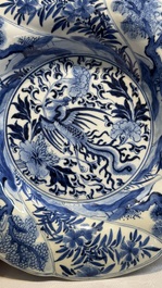 A Chinese blue and white 'phoenix and monkeys' dish and a pair of powder-blue-ground plates, Kangxi/Yongzheng