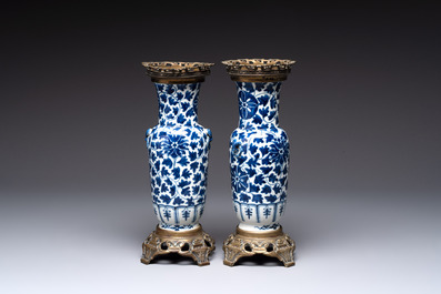 A pair of Chinese blue and white bronze-mounted vases and a covered jar, 19th C.