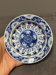 A Chinese blue and white reticulated double-walled cup and saucer, fu mark, Kangxi