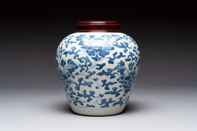 A Chinese blue and white 'peony scrolls' vase and wooden cover, Transitional period