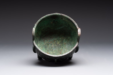 A Chinese archaic bronze tripod food vessel with 'taotie' design, 'ding 鼎', Western Zhou