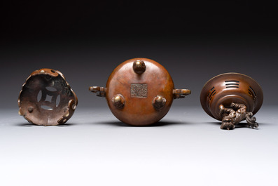 A Chinese bronze tripod censer with cover and stand, a small tripod censer and a silver-inlaid iron brush pot, 19/20th C.