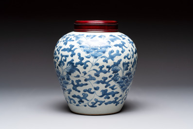 A Chinese blue and white 'peony scrolls' vase and wooden cover, Transitional period