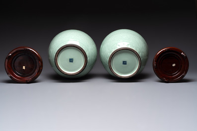 A pair of Chinese celadon-glazed vases with 'anhua' design on wooden stands, Qianlong mark, 19th C.