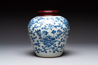 A Chinese blue and white 'peony scrolls' vase and wooden cover, Transitional period