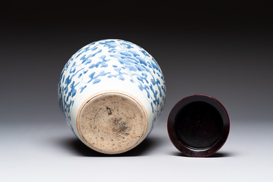 A Chinese blue and white 'peony scrolls' vase and wooden cover, Transitional period