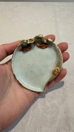 A Chinese iron-red gilt-decorated celadon-glazed peach-shaped brushwasher, 18th C.