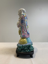 A Chinese famille rose Milefo Buddha on wooden stand, 19th C.