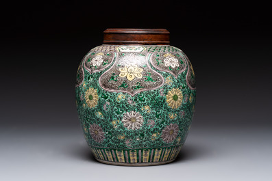 A Chinese verte biscuit 'lotus scroll' jar with wooden cover, Qing
