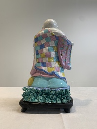 A Chinese famille rose Milefo Buddha on wooden stand, 19th C.