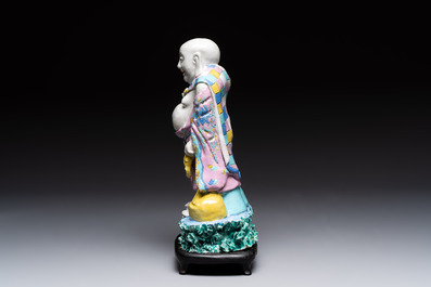 A Chinese famille rose Milefo Buddha on wooden stand, 19th C.