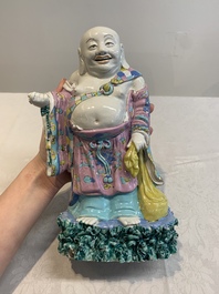 A Chinese famille rose Milefo Buddha on wooden stand, 19th C.
