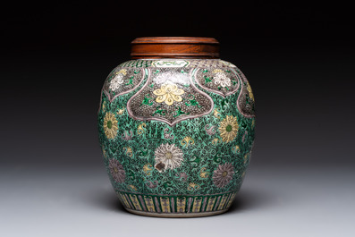 A Chinese verte biscuit 'lotus scroll' jar with wooden cover, Qing