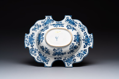 A very rare and large blue and white Dutch Delft double barber's bowl with floral design, late 17th C.