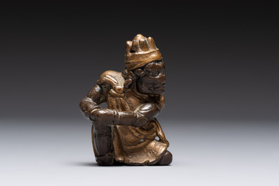 A small Chinese gilt bronze paperweight in the form of a kneeling foreigner, Ming