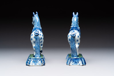 A pair of blue and white Dutch Delft prancing horses on a green-glazed base, 18th C.
