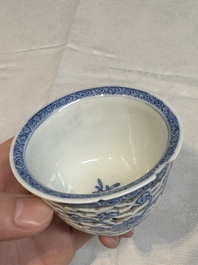 A pair of Chinese blue and white salts and a reticulated double-walled cup, Kangxi