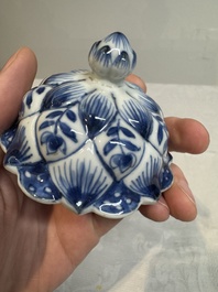 A pair of Chinese blue and white vases and covers with floral design, Kangxi