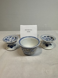 A pair of Chinese blue and white salts and a reticulated double-walled cup, Kangxi