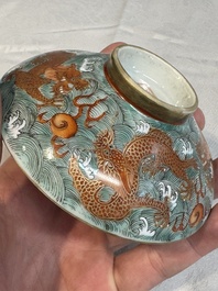 A Chinese fencai gilt-decorated 'dragons on waves' bowl and cover, Jiaqing mark, 19th C.