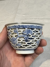 A pair of Chinese blue and white salts and a reticulated double-walled cup, Kangxi