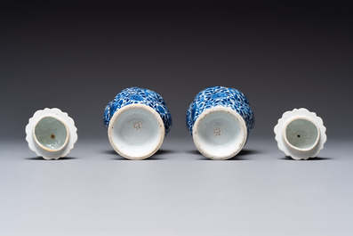 A pair of Chinese blue and white vases and covers with floral design, Kangxi