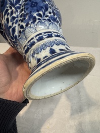 A pair of Chinese blue and white vases and covers with floral design, Kangxi