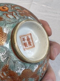 A Chinese fencai gilt-decorated 'dragons on waves' bowl and cover, Jiaqing mark, 19th C.
